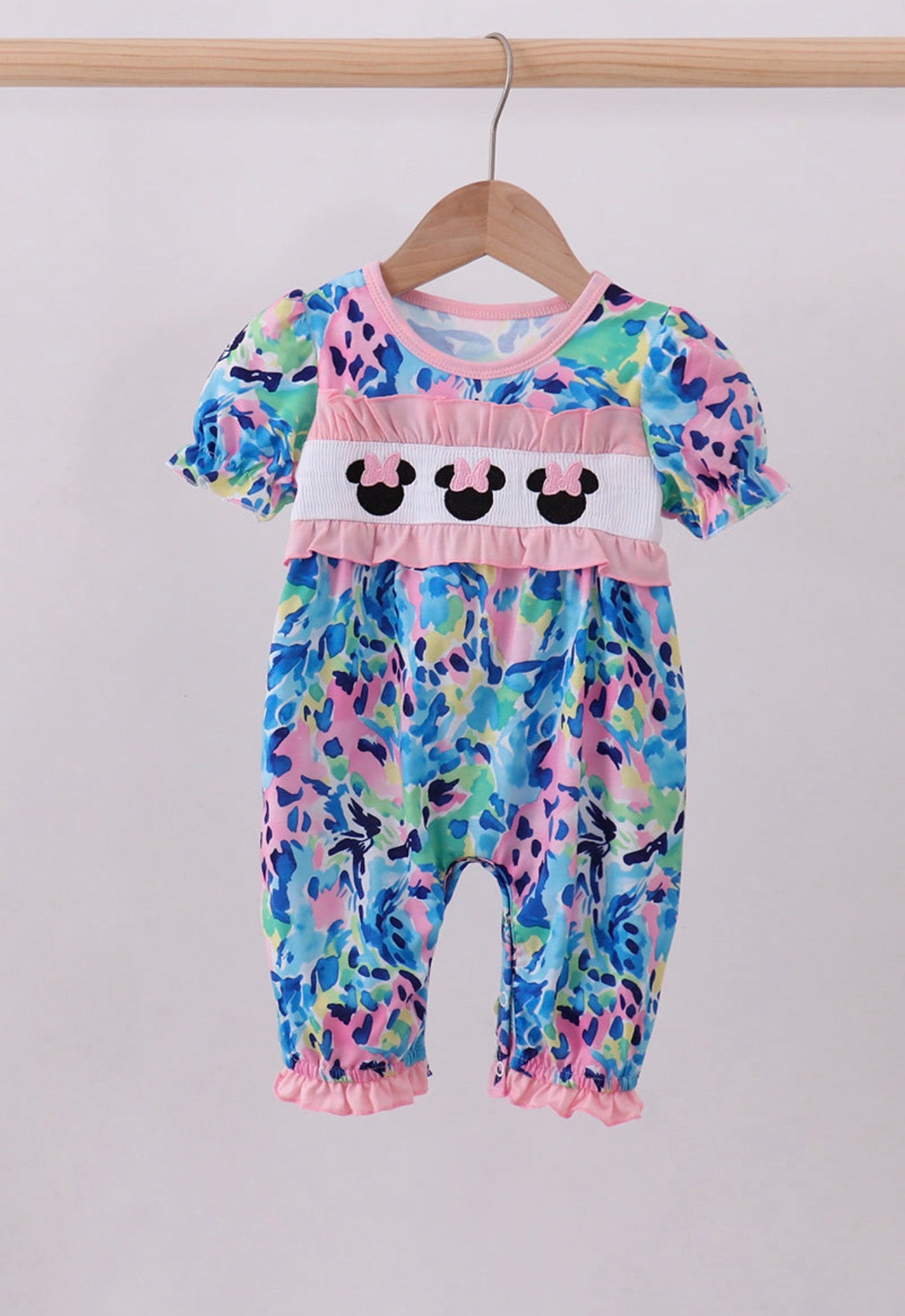 Pink character smocked ruffle romper