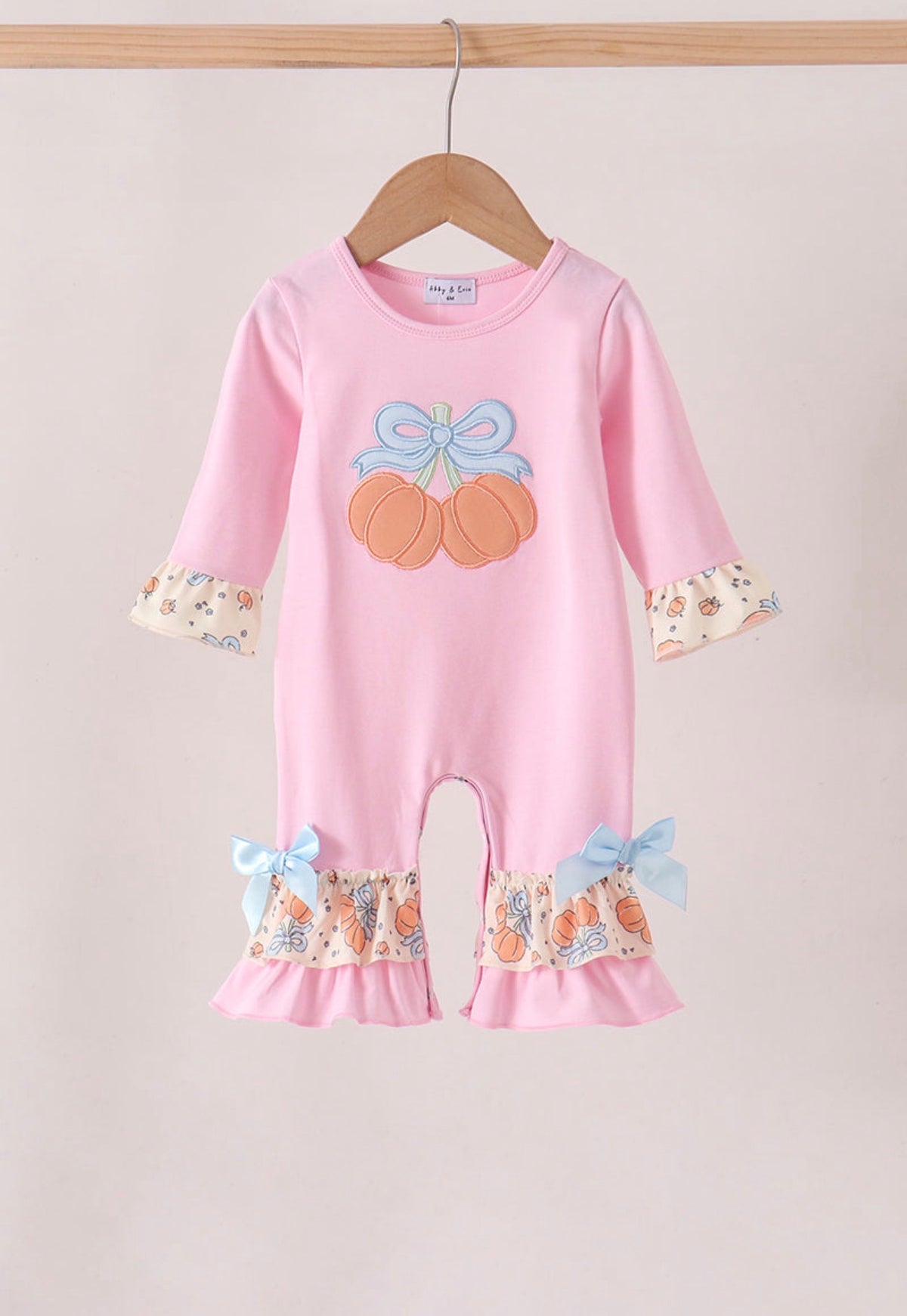 Pink bow pumpkin ruffle romper