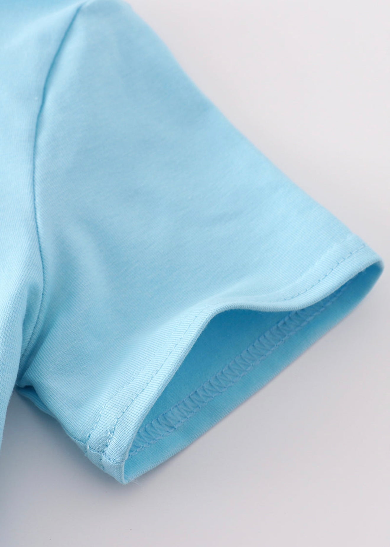 Blue fish appliqué top